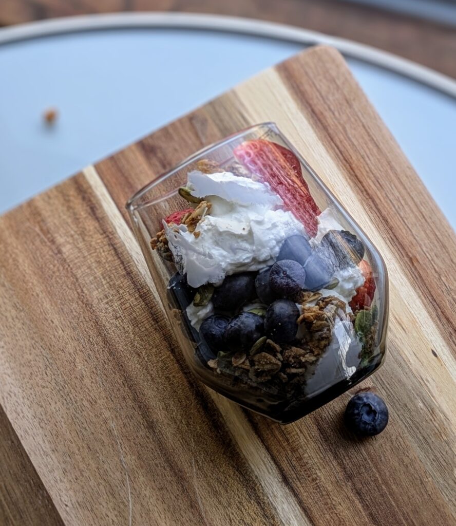 parfait cup with yogurt, berries, granola, pumpkin seeds